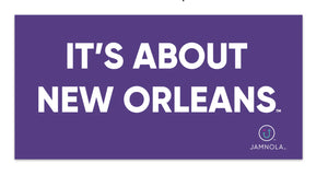 It's About New Orleans in white lettering on a purple background with JAMNOLA logo in the bottom right corner.