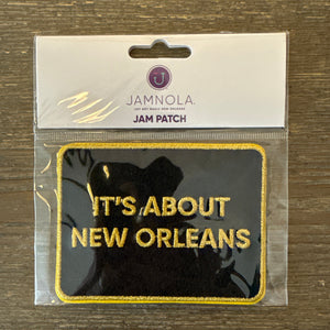 Black embroidered patch with it's about New Orleans  in gold letters
