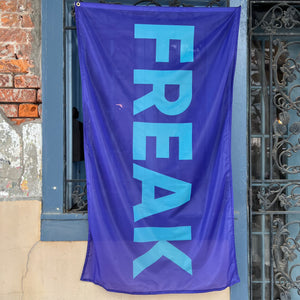 Purple Flag with the word Freak in Electric Blue lettering