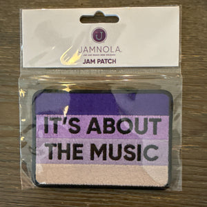 Purple ombre embroidered patch that says it's About the Music in Black letters