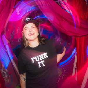 Person wearing a black 'Funk It' t-shirt with a colorful, abstract background