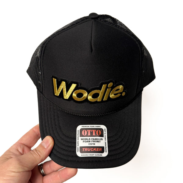 Black trucker hat with mesh back and Wodie logo patch