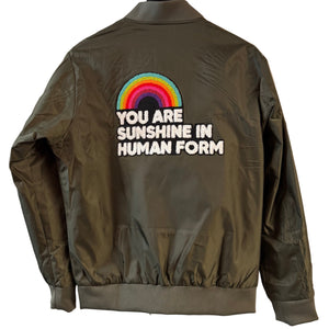 Green jacket with a rainbow and text design on a white background