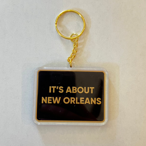 Black and Gold Acrylic keychain that says It's About New Orleans