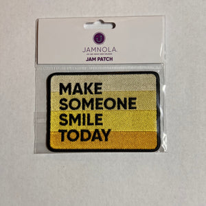 Embroidered patch with 'Make Someone Smile Today' text on an ombre yelow background