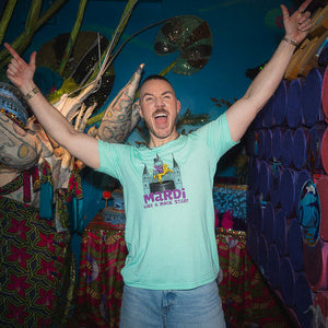 Man in a light blue t-shirt with a colorful background
