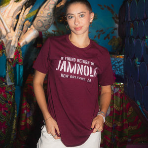 Woman wearing a maroon t-shirt with text, standing in JAMNOLA on Frenchmen Street.