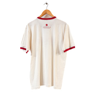 White t-shirt with red trim on a wooden hanger against a white background