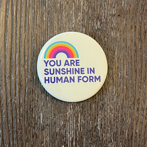 Round magnet with a rainbow and you are sunshine in human form on it