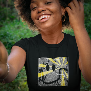 Woman's Nola Is My Happy Place Smiley Map Tee using the ben of the river as a smiley